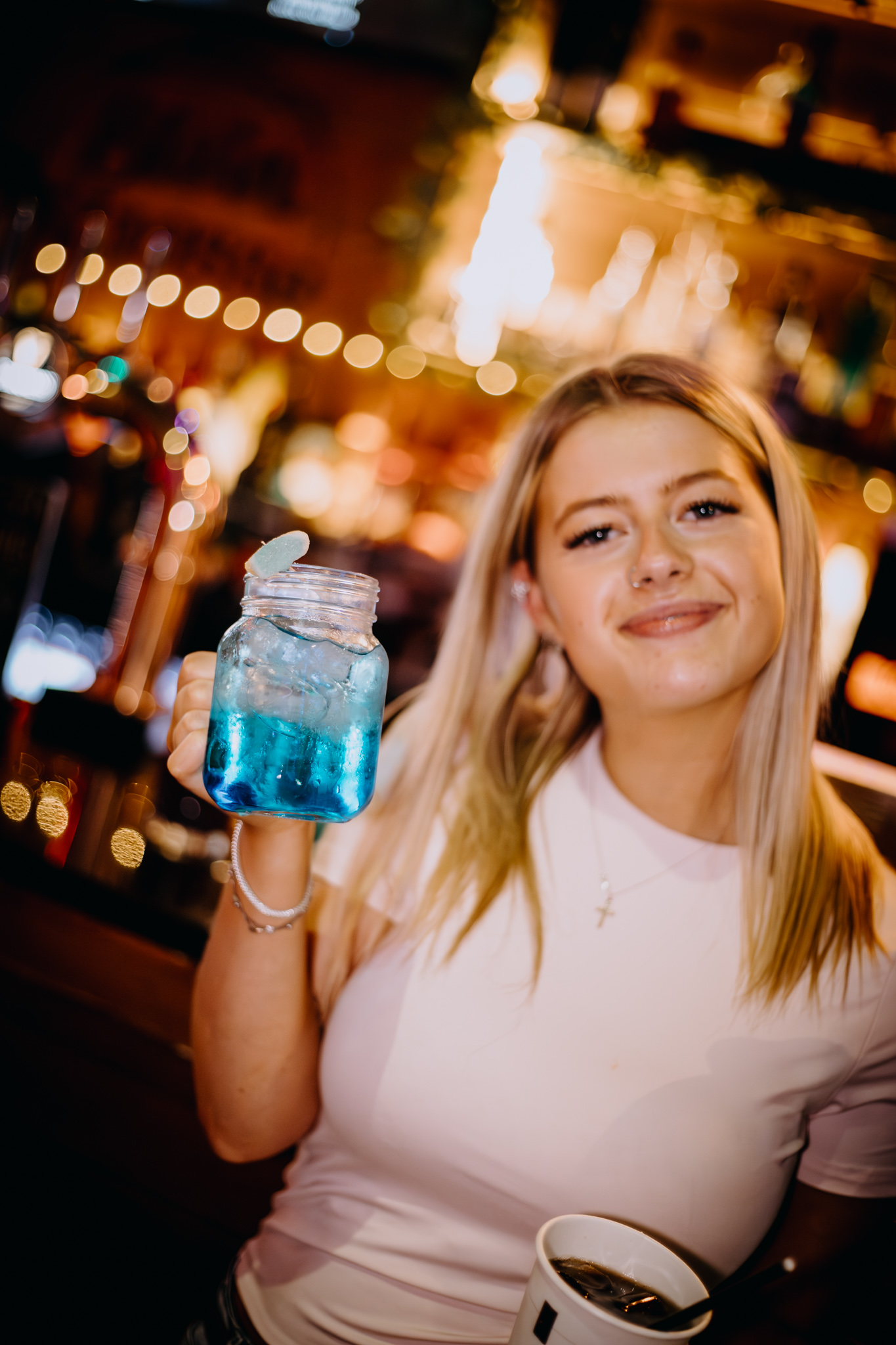 A guest holding a blue cocktail stein at STEINS