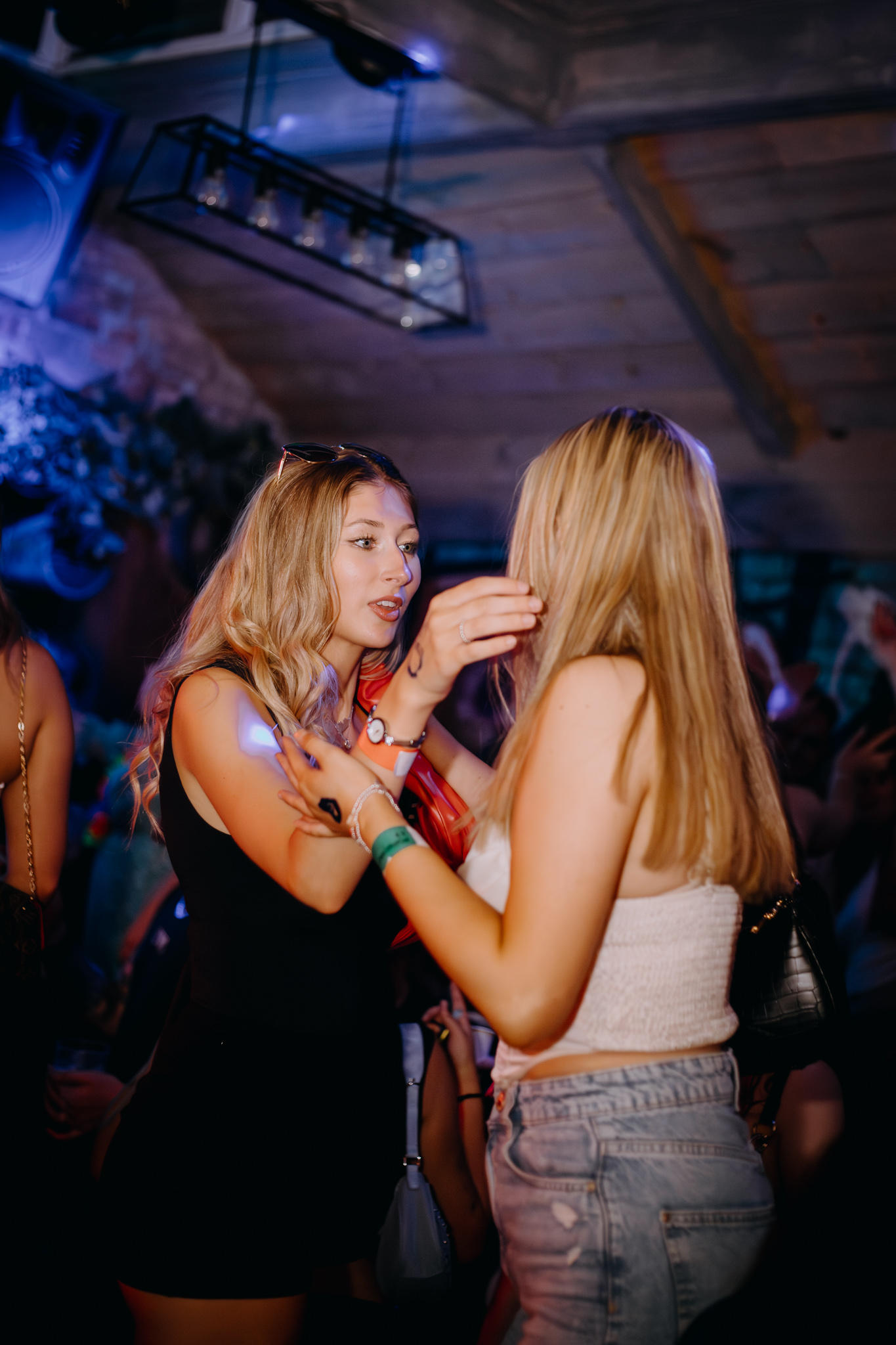 Two guests chatting beneath the venue lights